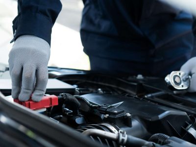 Machanic Checking and change the battery in garage. Repair service.Car repair and maintenanc concept